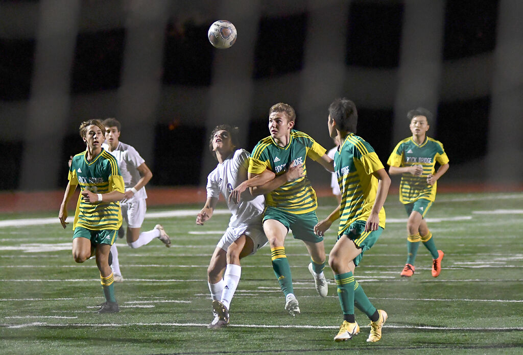Hickman senior Lake Gott and Rock Bridge junior Max Juengermann fight for the ball